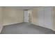 Spacious bedroom featuring a large closet, carpet and access to the upper level stairs at 1330 Quari St, Aurora, CO 80011