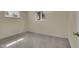 A simple bedroom bathed in light with two windows and neutral carpet at 1330 Quari St, Aurora, CO 80011