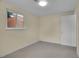 Cozy bedroom with neutral carpet and walls, and a view of the brick building next door at 1330 Quari St, Aurora, CO 80011