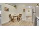 Cozy dining area with a round table, hardwood floors and a doorway leading to another room at 1330 Quari St, Aurora, CO 80011