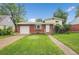 Charming brick home with a well-maintained lawn, attached garage and inviting curb appeal at 1330 Quari St, Aurora, CO 80011