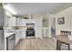 Bright kitchen featuring stainless steel appliances, white cabinets, and new hard surface floors at 1330 Quari St, Aurora, CO 80011