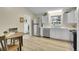 Bright eat-in kitchen featuring modern appliances, wood laminate flooring and white cabinetry at 1330 Quari St, Aurora, CO 80011
