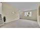 Inviting living room with soft carpet, bright bay window, and neutral paint colors at 1330 Quari St, Aurora, CO 80011