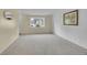 Cozy living room with neutral carpet, bright bay window, and soft, neutral wall colors at 1330 Quari St, Aurora, CO 80011