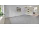 Bright living room with soft carpet, built in shelving, with natural light and neutral paint at 1330 Quari St, Aurora, CO 80011
