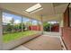 Enclosed sunroom showcasing bright natural light with views of the backyard and its vibrant green space at 1330 Quari St, Aurora, CO 80011