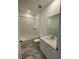 Clean bathroom featuring a shower over tub, modern vanity with white countertops and tile flooring at 16552 E 109Th Ave, Commerce City, CO 80022