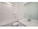 Clean bathroom featuring a shower-over-tub, modern vanity with mirror, and tiled walls at 16552 E 109Th Ave, Commerce City, CO 80022