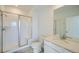 Modern bathroom with a glass-enclosed shower, white vanity, and marble-like tile flooring at 16552 E 109Th Ave, Commerce City, CO 80022