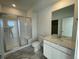 Modern bathroom features a glass shower and large vanity with a large mirror at 16552 E 109Th Ave, Commerce City, CO 80022