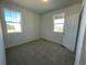 Bright bedroom with two large windows and neutral carpet, offering a cozy and inviting space at 16552 E 109Th Ave, Commerce City, CO 80022