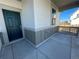 Close-up of the front door with gray siding, a window, and a covered porch at 16552 E 109Th Ave, Commerce City, CO 80022