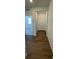 Inviting hallway with wood-look tile flooring leading to a bright white front door at 16552 E 109Th Ave, Commerce City, CO 80022