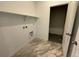 Functional laundry room with tile floors, shelf, and washer/dryer hookups at 16552 E 109Th Ave, Commerce City, CO 80022