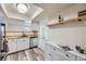 Bright kitchen featuring stainless steel appliances, white cabinetry, and a wood countertop at 3550 S Harlan St # 182, Denver, CO 80235