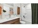 Traditional bathroom featuring a shower-tub combo and earth-tone decor at 22272 E 7Th Pl, Aurora, CO 80018