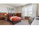 Modern bedroom showcasing stylish decor, a large window and a dedicated workspace at 22272 E 7Th Pl, Aurora, CO 80018