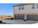 Exterior view of a two-story townhome featuring a two-car garage at 22272 E 7Th Pl, Aurora, CO 80018