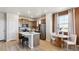 A bright kitchen with quartz countertops, stainless steel appliances, and a cozy dining space at 22272 E 7Th Pl, Aurora, CO 80018