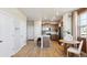 Modern kitchen featuring an island with seating, stainless steel appliances, and a connected dining area at 22272 E 7Th Pl, Aurora, CO 80018
