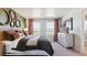 Serene main bedroom with decorative wall art, plush bedding, and a soothing color palette at 22272 E 7Th Pl, Aurora, CO 80018