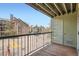Apartment balcony with a black metal railing offering neighborhood views and an outdoor storage closet at 4899 S Dudley St # 15G, Littleton, CO 80123