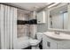 Bathroom featuring white vanity, mirror, toilet, and shower with decorative tile at 4899 S Dudley St # 15G, Littleton, CO 80123