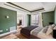 Bedroom with a tray ceiling, large window, and ensuite access at 4899 S Dudley St # 15G, Littleton, CO 80123