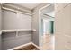 View of a closet featuring shelving and an open doorway that leads to a room with wood-look flooring at 4899 S Dudley St # 15G, Littleton, CO 80123