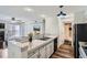 Modern kitchen with a breakfast bar, stainless steel appliances, and an adjacent dining area at 4899 S Dudley St # 15G, Littleton, CO 80123