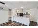 Bright kitchen with stainless steel appliances, white cabinetry, black accents and wood-look flooring at 4899 S Dudley St # 15G, Littleton, CO 80123