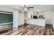 Open living space with modern wood flooring and an adjoining kitchen at 4899 S Dudley St # 15G, Littleton, CO 80123