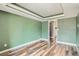 Open-concept living room with wood-look flooring and a view of the hallway at 4899 S Dudley St # 15G, Littleton, CO 80123