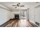 Living room with fireplace, access to a balcony and built in shelves at 4899 S Dudley St # 15G, Littleton, CO 80123