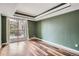 Sunny living room with wood-look flooring and access to a private balcony at 4899 S Dudley St # 15G, Littleton, CO 80123