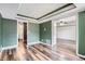 Open-concept living room with wood-look flooring and access to a bathroom and bedroom at 4899 S Dudley St # 15G, Littleton, CO 80123