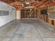 Spacious unfinished garage with concrete floors, open wood beam ceilings, and ample room for storage and parking at 1584 S Salem Cir, Aurora, CO 80012