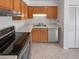 Well-lit kitchen with stainless steel appliances, light wood cabinets, and a double basin sink at 1584 S Salem Cir, Aurora, CO 80012