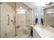 Elegant bathroom with a glass-enclosed shower, neutral tile, and a double vanity, offering a spa-like experience at 1143 Auraria Pkwy # 203, Denver, CO 80204