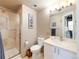 Bathroom featuring a glass-enclosed shower, modern fixtures, and a neutral color scheme at 1143 Auraria Pkwy # 203, Denver, CO 80204