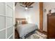 Bedroom with stylish furnishings, a ceiling fan, and natural light from large windows at 1143 Auraria Pkwy # 203, Denver, CO 80204