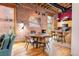 Bright dining area with modern table, kitchen in the background, and exposed brick wall at 1143 Auraria Pkwy # 203, Denver, CO 80204