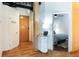 Entryway with hardwood floors, access to a powder room, storage, and view into the bedroom at 1143 Auraria Pkwy # 203, Denver, CO 80204