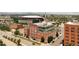 Stunning exterior view of a brick building with a modern glass rooftop addition, set against a vibrant cityscape backdrop at 1143 Auraria Pkwy # 203, Denver, CO 80204