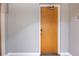 The entry to unit 203 features a wood door with modern hardware and electronic lock at 1143 Auraria Pkwy # 203, Denver, CO 80204