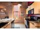 Charming kitchen with exposed brick, updated appliances, and a view, blending rustic charm with modern amenities at 1143 Auraria Pkwy # 203, Denver, CO 80204