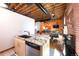 Open-concept living area featuring exposed brick, hardwood floors, and modern furnishings at 1143 Auraria Pkwy # 203, Denver, CO 80204