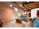 Exposed brick wall and ductwork give this living room an industrial, modern feel at 1143 Auraria Pkwy # 203, Denver, CO 80204