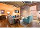 Living room featuring hardwood floors, modern lighting, and exposed ductwork at 1143 Auraria Pkwy # 203, Denver, CO 80204